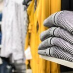 selective-focus-photo-of-stack-of-sweaters-on-shel-2025-03-10-05-49-18-utc